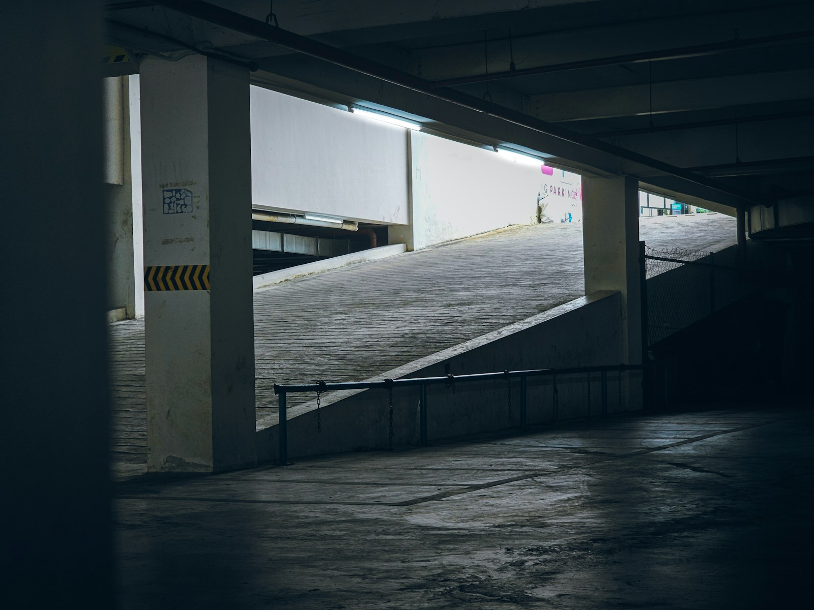 An empty parking garage with a ramp leading up to it