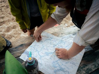 A group of people standing around a map