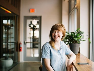 woman sitting in front of brown wooden table