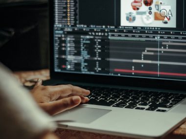 person using macbook pro on table