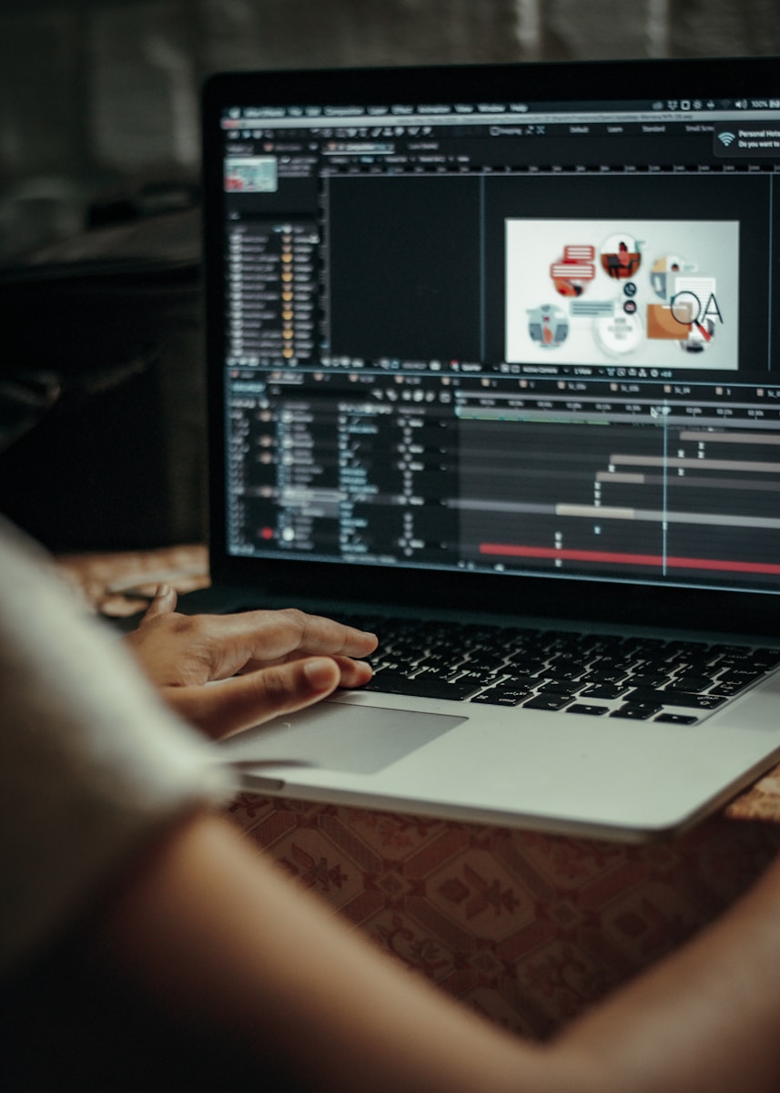 person using macbook pro on table