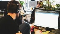 man in black shirt wearing black headphones